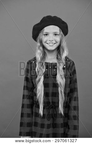How To Wear Beret Like Fashion Girl. Kid Little Cute Girl With Long Hair Posing In Hat Red Backgroun