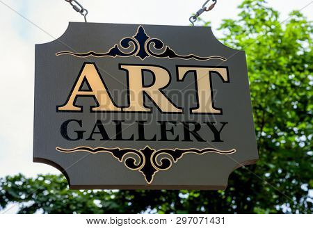 Wooden suspended art gallary sign.