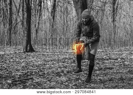 A Man In Training Clothes Got A Knee Injury While Jogging In Outdoor Workout. Concept Of Sports Inju