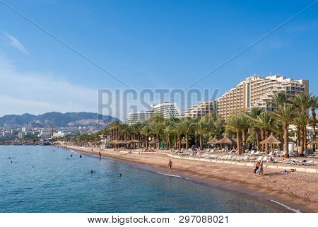 Eilat, Israel - November 28, 2018: City beach with luxury hotels at Eilat seafront. Eilat is a famous resort city on the red sea in Israel