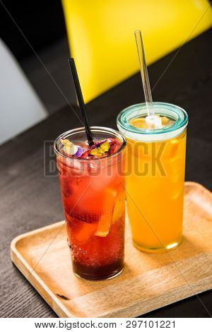 fresh lemonade with  straws with fresh strawberry and orange on a bar table