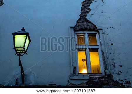 Window With A Crack And Street Lamp In The Evening In One Of The Small Streets Of Bratislava Old Cit