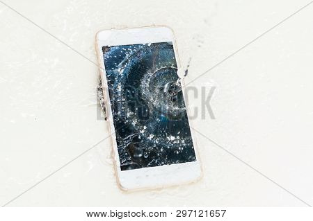 Phone Dropped Into The Water. Telephone And Water Spra