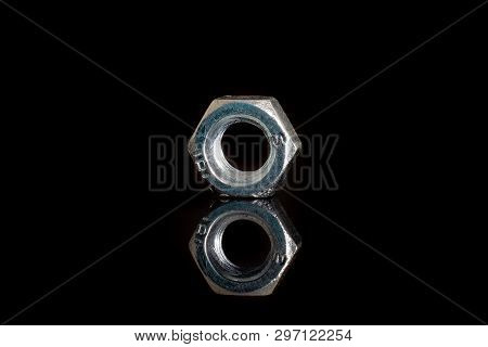 One Whole Metal Locking Nut Work Item Closeup Isolated On Black Glass