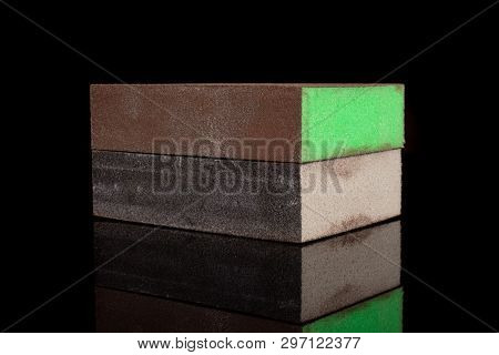 Group Of Two Whole Grey And Green Abrasive Block Sponges Work Item Isolated On Black Glass