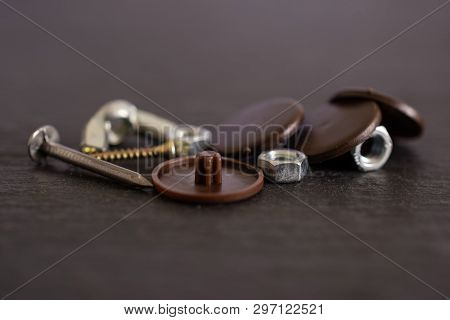 Lot Of Whole Work Item Plast Plugs, Metal Nails And Nuts On Grey Stone