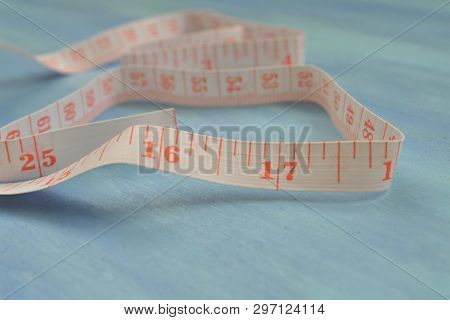 Tape Measure Half-rolled Out. Measuring Cm And Inches. Tailoring Tools. Pocket Measure.