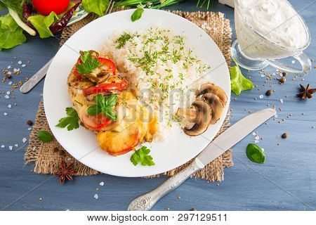 Fired Cordon Bleu Chicken Served With Rice And Parsley On Plate. Chicken Fillet Baked In Cheese With