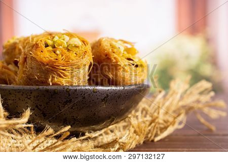 Closeup Of Three Whole Sweet Lebanese Baklava Piece Bird Nest Variety On Grey Ceramic Plate On Jute 