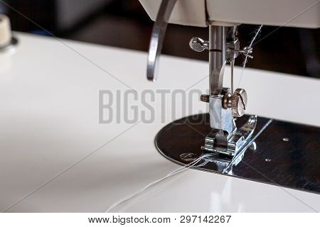 Shuttle With A Needle. Part Of An Electric Sewing Machine Close Up.