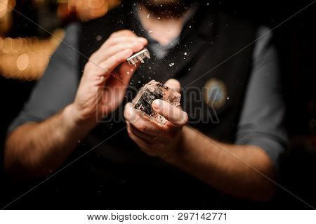 Close-up Of Male Bartender Crushing Ice With Ice Crusher
