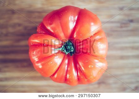 Oxheart Tomatoes. Tomato On A Bamboo Wood Plate.