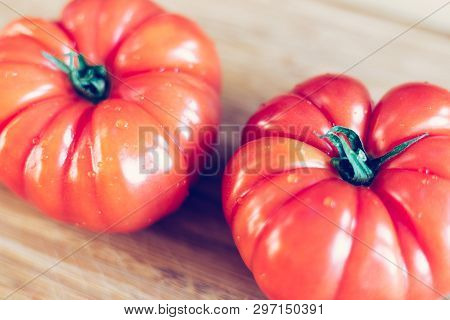 Oxheart Tomatoes. Tomatoes On A Bamboo Wood Plate.