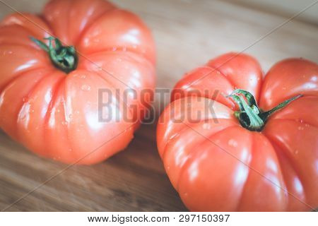 Oxheart Tomatoes. Tomatoes On A Bamboo Wood Plate.