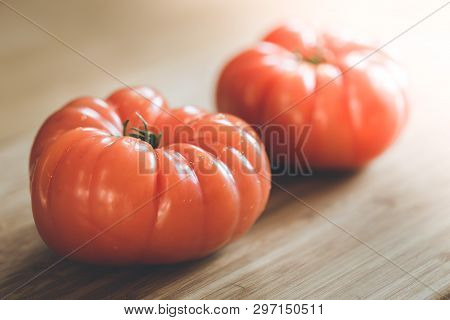 Oxheart Tomatoes. Tomatoes On A Bamboo Wood Plate.