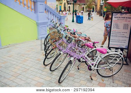 Nha Trang, Vietnam - February 17, 2018: Row Of Bicycle Style Classic With Seats At Sidewalk Parking.