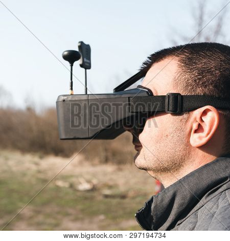 Fpv Drone Pilot In A Virtual Reality Helmet With A Remote Control From A Copter Flies In Aircraft Ou