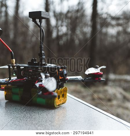 Fpv Drone Lies On The Table. The Pilot Sets Up His Racing Drone Before The Flight.
