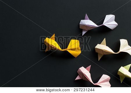 Handmade Paper Craft Origami Gold Koi Carp Fishes On Black Background.top View, Pattern