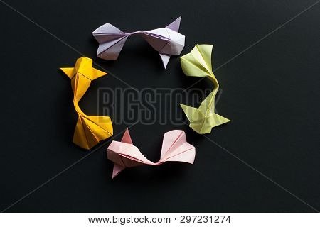 Handmade Paper Craft Origami Gold Koi Carp Fishes On Black Background.top View, Pattern