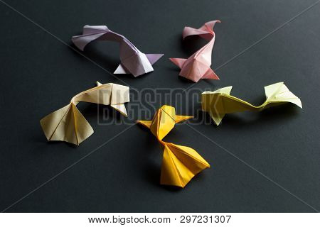 Handmade Paper Craft Origami Gold Koi Carp Fishes On Black Background.top View, Pattern