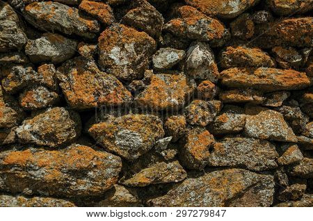 Close-up Of Wall Made Of Rough Stones Covered By Moss And Lichens, Forming A Singular Pattern At Evo