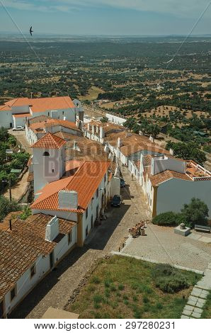 View Of The Small Village Main Street And Countryside Landscape With Green Hills At Evoramonte. A Ti