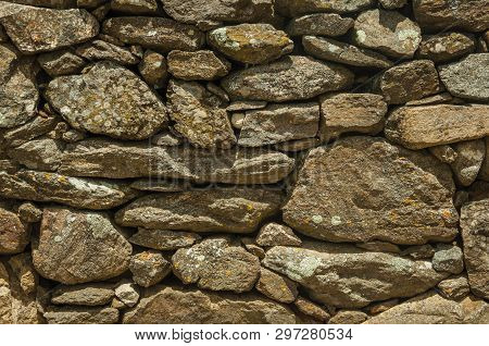 Close-up Of Wall Made Of Rough Stones Covered By Moss And Lichens, Forming A Singular Pattern At Evo