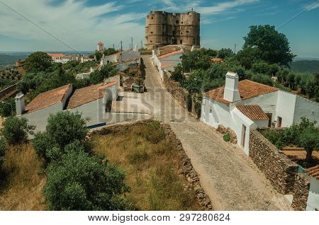 Landscape Of Empty Main Cobblestone Street In A Sunny Day And The Castle On Background At Evoramonte