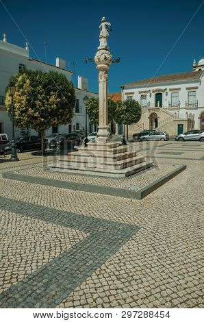 Marble Pillory And Sculpture On Top In Deserted Square With Old Buildings, In A Sunny Day At Campo M