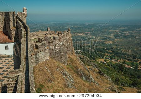 Pathway And Stairs On Top Of Thick Stone Wall And Watchtowers Over Countryside Landscape At The Marv