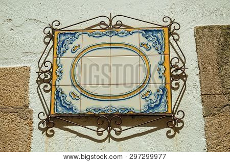 Blank Signboard Made Of Ceramic Tiles With Iron Decoration, Stuck To Wall At Castelo De Vide. Little