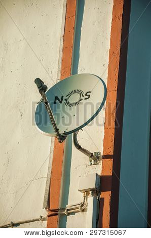 Elvas, Portugal - July 05, 2018. Parabolic Antenna At Sunset, Stuck On The Wall Of Country House Nea