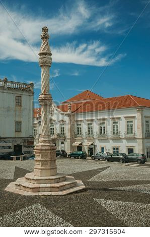 Estremoz, Portugal - July 6, 2018. Pillory in the foreground on square with old buildings around in sunny day at Estremoz. A nice little historic town with several marble buildings on eastern Portugal