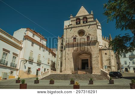 Elvas, Portugal - July 7, 2018. Our Lady of the Assumption Cathedral and old buildings on a square, in a sunny day at Elvas. A star-shaped fortress city on the easternmost frontier of Portugal.