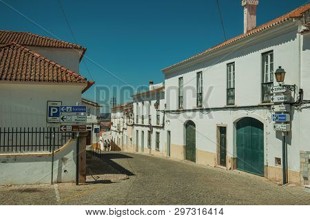 Elvas, Portugal - July 07, 2018. Street signs indicating public services and city attractions in a deserted street of Elvas. A star-shaped fortress city on the easternmost frontier of Portugal.