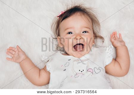 Portrait Of A Newborn Baby With His Tongue Sticking Out
