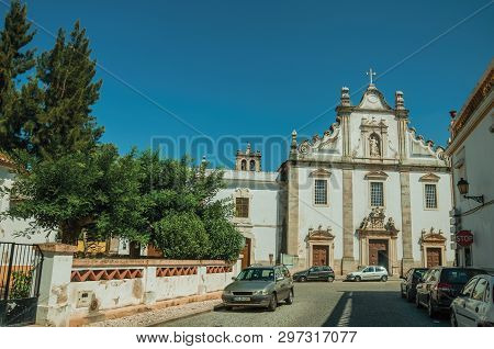 Elvas, Portugal - July 07, 2018. Baroque Church of Sao Domingos in front of deserted street on a sunny day at Elvas. A gracious star-shaped fortress city on the easternmost frontier of Portugal.