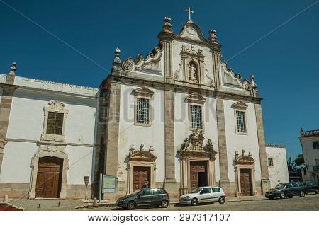 Elvas, Portugal - July 07, 2018. Baroque Church of Sao Domingos in front of deserted street on a sunny day at Elvas. A gracious star-shaped fortress city on the easternmost frontier of Portugal.
