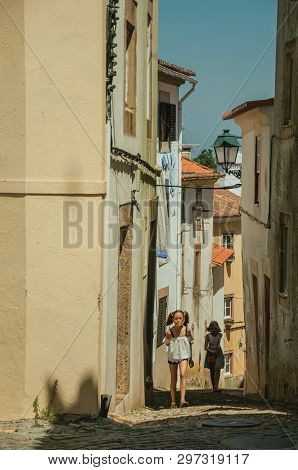 Castelo De Vide, Portugal - July 10, 2018. Two Little Girls Walking Up The Alley Among Old Houses At