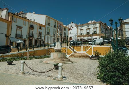 Castelo De Vide, Portugal - July 10, 2018. Old Colorful Houses Around Square With Marble Statue At C