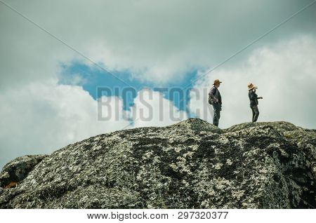 Serra Da Estrela, Portugal - July 12, 2018. Couple Of Hikers On Top Of Rocks At Highlands In The Ser