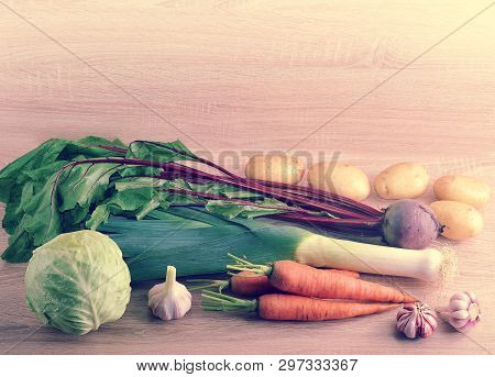 Set Of Raw Vegetables For Healthy Eating, Leek, Beets, Potatoes, Carrots, Cabbage, Garlic On A Woode