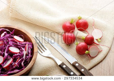 Salad Of Radishes And Red Cabbage In A Wooden Plate And Stroye Devices - A Vegetarian Dish - Top Vie