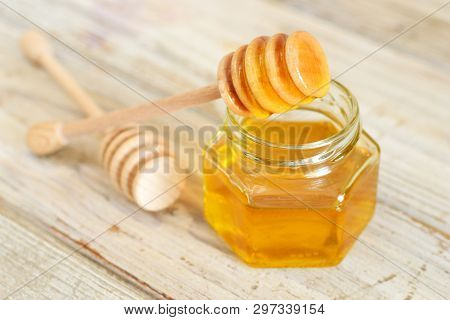 Honey In Gladd With Wooden Dipper Or Honeyspoon