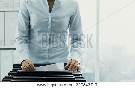 Office Worker Searching Files In The Archive