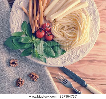 Various Types Of Cheese In A Bowl With Basil And Cherry Tomatoes - Cheese Chechil, Straws, Smoked Ch