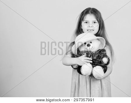 Cutest Ever. Kid Little Girl Carefully Hug Soft Toy Teddy Bear Beige Background. Tender Attachments.