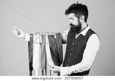 Tie The Perfect For Daily Wear. Bearded Man Choosing Neck Tie. Brutal Hipster Holding Colorful Tie C