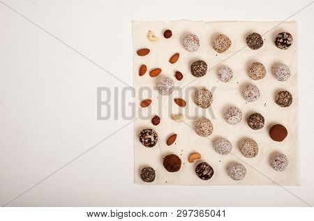 Homemade Energy Balls Consisting Of Several Different Colors And Flawors Served On The Parchment Pap